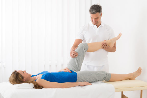 Woman Receiving Leg Massage In Spa